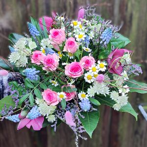 runder Strauß mit pinken verzweigten Rosen, Muscari, Nigella, Lenzrosen, Kamille